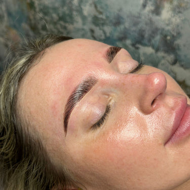 Beauty student applying hybrid brow dye for skin-stained, bold brows during London Brow online training.