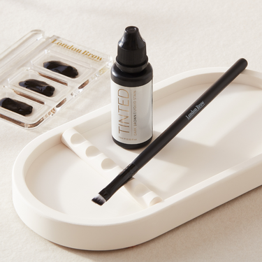 Online brow tinting course showing students applying tinted liquid stain for bold, long-lasting brow definition.